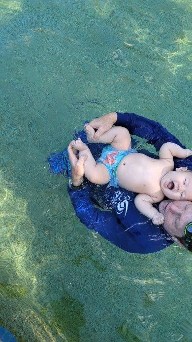 Baby floating on their back in the pool